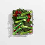 Basket filled with green vegetables and berries labeled 'Daily Greens' on a white background